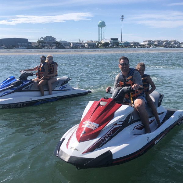A family on 2 jet ski's.
