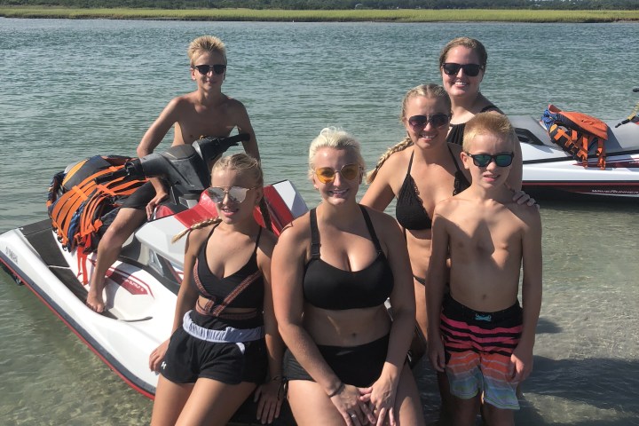 A family getting ready to ride jet ski's.