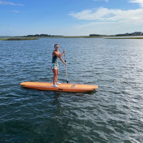 a man riding on the back of a boat in the water