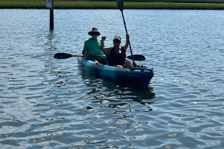 a person riding on the back of a boat in a body of water