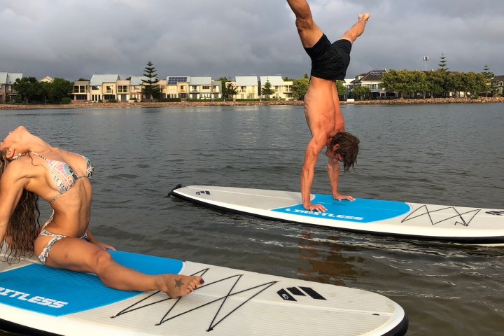 a person sitting next to a body of water