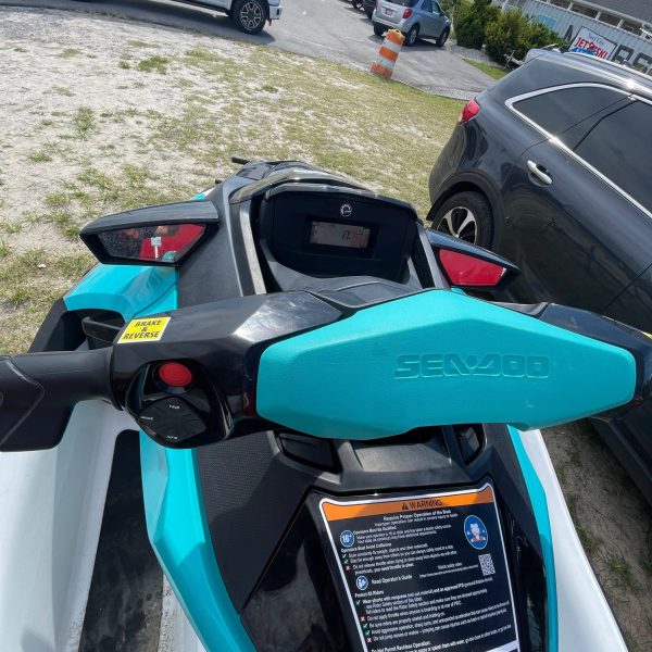 a close up of a blue car parked in a parking lot