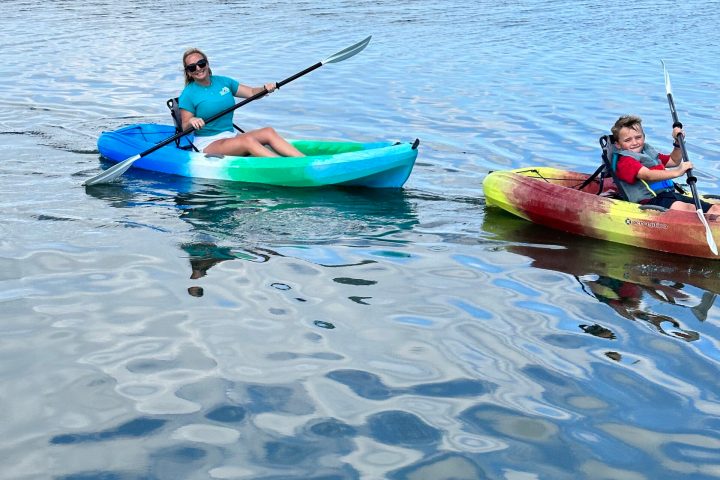 a group of people rowing a boat in a body of water