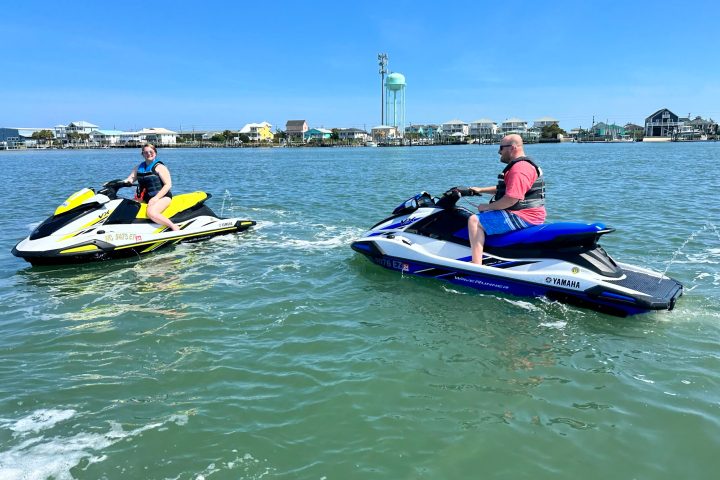 a group of people rowing a boat in the water