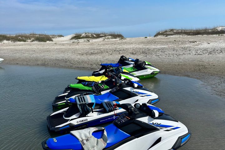 a boat sitting on top of a sandy beach