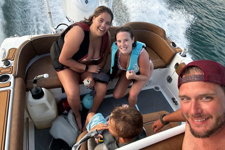 a man and a woman sitting on a boat in the water