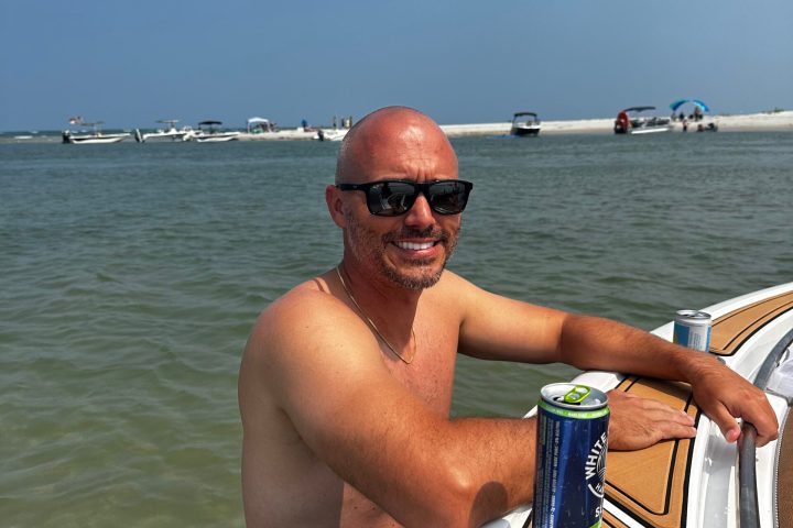 a man standing next to a body of water