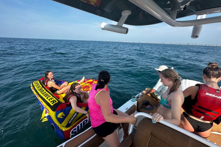 a group of people in a boat on a body of water
