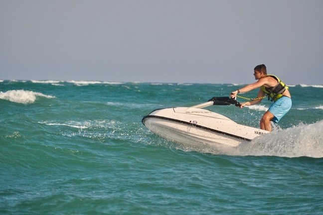 a man riding a wave on a surfboard in the water