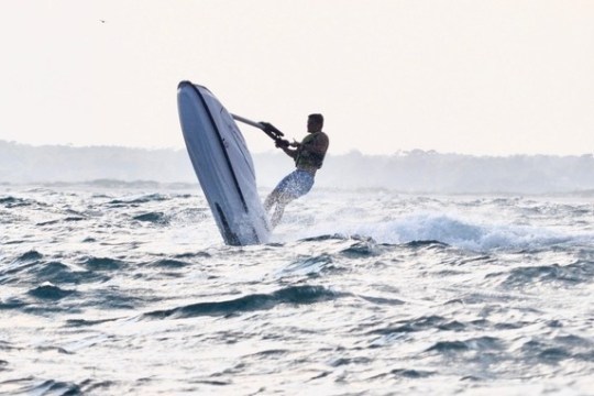 a person riding a surf board on a body of water